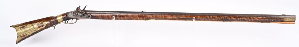 FINE CARVED KENTUCKY RIFLE BY NATHANIEL ROWE: SERIAL NUMBER: NSN. BARREL: 44-1/2". CALIBER: .60 SMOOTHBORE FLINTLOCK BLACKPOWDER. MANUFACTURED: Circa 1820's. Nathaniel Rowe, trained by John Armstrong of Maryland. Full octagon barrel, signed in sc