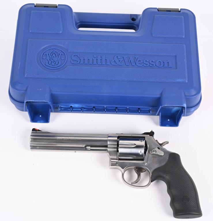 SMITH & WESSON MODEL 686-6: SERIAL NUMBER: DPV5643. BARREL: 6". CALIBER: .357 MAG. MANUFACTURED: 2000's. Standard markings. Six shot fluted cylinder. Ramped blade front sight and adjustable u-notch rear. Polished stainless steel