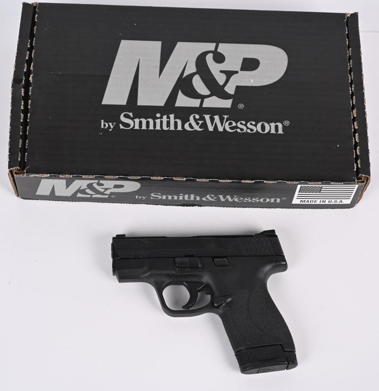 SMITH & WESSON M&P 9 SHIELD SEMI AUTO PISTOL: SERIAL NUMBER: HYV8921. BARREL: 3". CALIBER: 9MM LUGER. MANUFACTURED: 2010's. Standard 3-dot sights. Matte black slide and black polymer frame. Includes two factory magazines (one seven rounder, one e