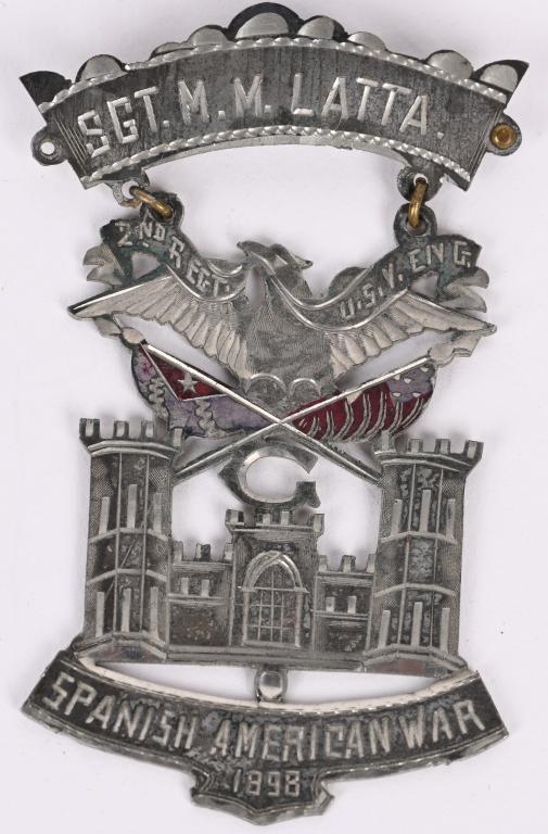 SPANISH AMERICAN WAR ENGINEER BADGE NAMED: Beautiful hand made badge from an Engineer of G Company named Sgt. M. M. Latta. The badge measures 3 1/4 inches tall having the Engineer Castle with a Federal Eagle with crossed Cuban and American Fla