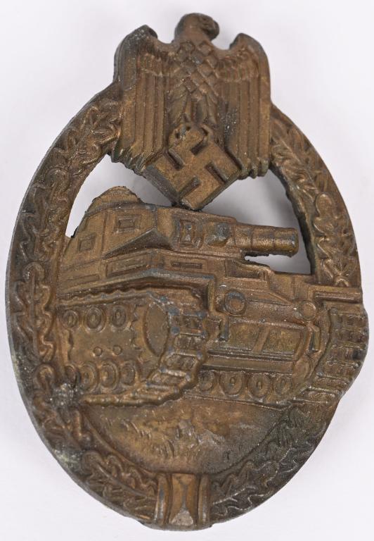 WWII NAZI GERMAN BRONZE PANZER BADGE BY E.W.E. WW2: Die struck, alloy construction, solid backed, badge with a bronze washed finish features a vertically oval, oak-leave wreath with a Wehrmacht style eagle with down-swept wings, clutching a canted swas