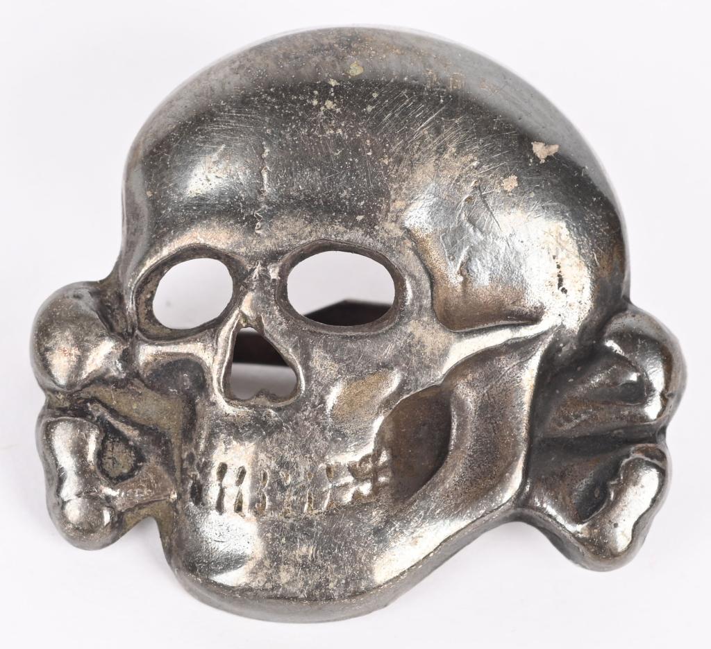 WWII NAZI GERMAN SS VISOR CAP SKULL M1/52 WW2: Second pattern, (Circa 1934-1945), nickle/silvered, die stamped alloy construction skull and cross bones features detailed eye and nose cut-outs, two rows of teeth and a bottom jaw, superimposed over 