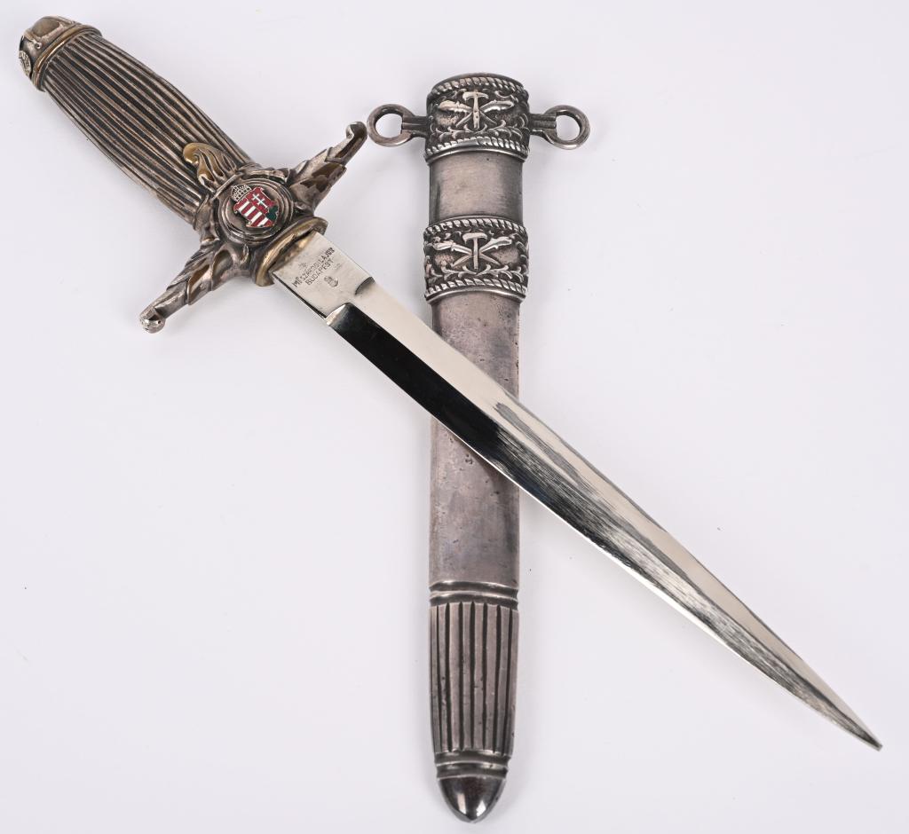WWII HUNGARIAN FIRE BRIGADE DRESS DAGGER WW2: Hungarian Fire Brigade dress dagger. Steel blade with metal grip, silvered cross guard and pommel, and silvered scabbard. Maker marked Meszaros Lajos Budapest with Hungarian small coat of arms. In ver