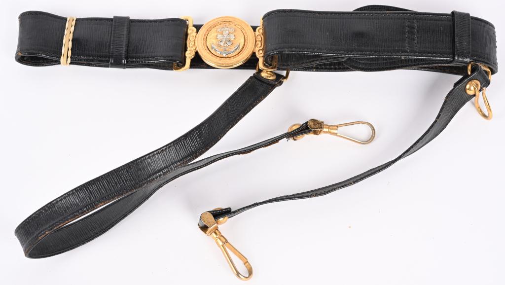 WWII IMPERIAL JAPANESE NAVY OFFICER BELT WW2: This is a WW II Japanese officers sword belt with the hangers. The interlocking buckle is made of brass with a silver anchor and cherry blossom in the center. The belt is black leather, and has two ha