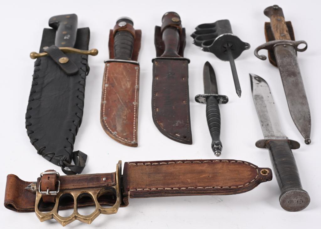 WW1 & WWII MILITARY KNIFE LOT KNUCKLE WESTERN CASE: Military knives lot to include include 1) V-44 Survival Knife in black leather scabbard 2) Repro M1918 Brass Knuckle Knife. with Leather Scabbard. 3) Western Knife measuring 12 3/4 inches with no scab