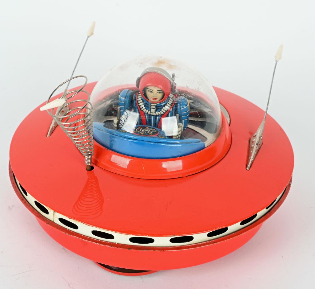 KO BATTERY OP FLYING SAUCER: KO battery operated Flying Saucer. Made in Japan. All original and complete with great looking Spaceman Driver. Worked when tested. 7 1/2" Excellent