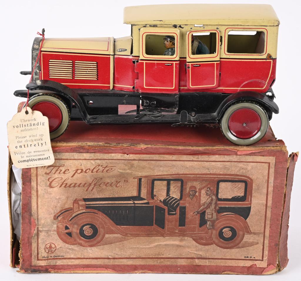 HANS EBERL THE POLITE CHAUFFEUR w/ BOX: RARE German tin windup The Polite Chauffeur. Great looking Limousine that Chauffeur hops out of the car and opens the door for the lady passenger. All original and looks never played with condition. W