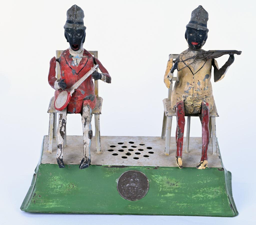 GUNTHERMANN HAND-PAINTED MINSTREL MUSICIANS: Wonderful German Hand-Painted Tin Minstrel Musicians. One figure plays the fiddle and mead moves. The other figure plays the banjo and his tongue moves. The toy is musical with plink plunk sounds. Wor