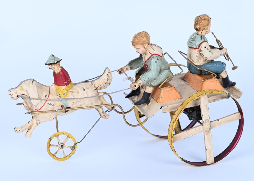 GERMAN HAND-PAINTED WINDUP DOG PULLING CART: Wonderful German Hand-Painted Tin Dog with Rider Pulling Cart with Children. Toy has been professionally restored to the highest standards. Windup works well. Large and impressive toy. 12" Excellent
