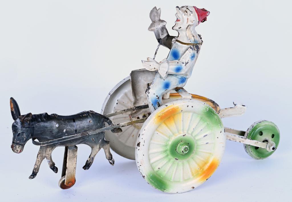 GUNTHERMANN HAND-PAINTED WINDUP CLOWN DONKEY CART: German Hand-Painted Tin Donkey cart. All original with nice colors. Has working squeeze type windup. 12 1/2" Excellent