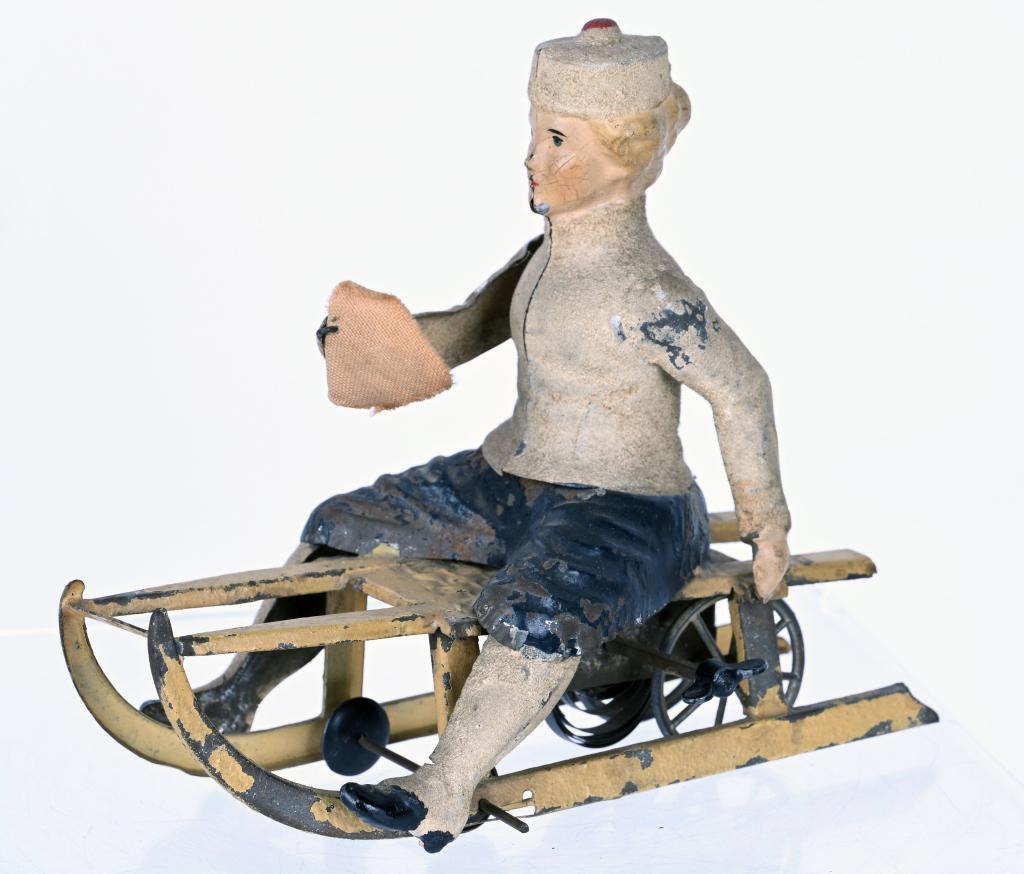 GUNTHERMANN HAND-PAINTED WINDUP GIRL ON SLED: German Hand-Painted Tin Girl On Sled. Beautiful original condition. Windup works. 6" Excellent