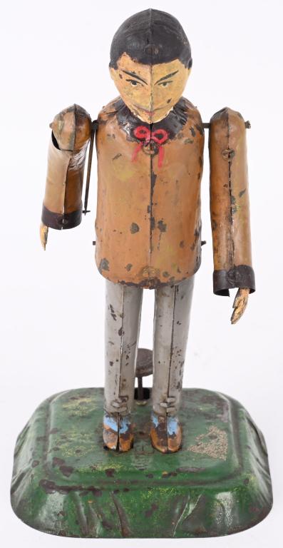 MARTIN THE BOWLER: Martin The Bowler. Push the lever and the man's arm throws the bowling balls. Made to put marbles in his arm. Toy has some professional paint touchup. 8 1/2" Excellent