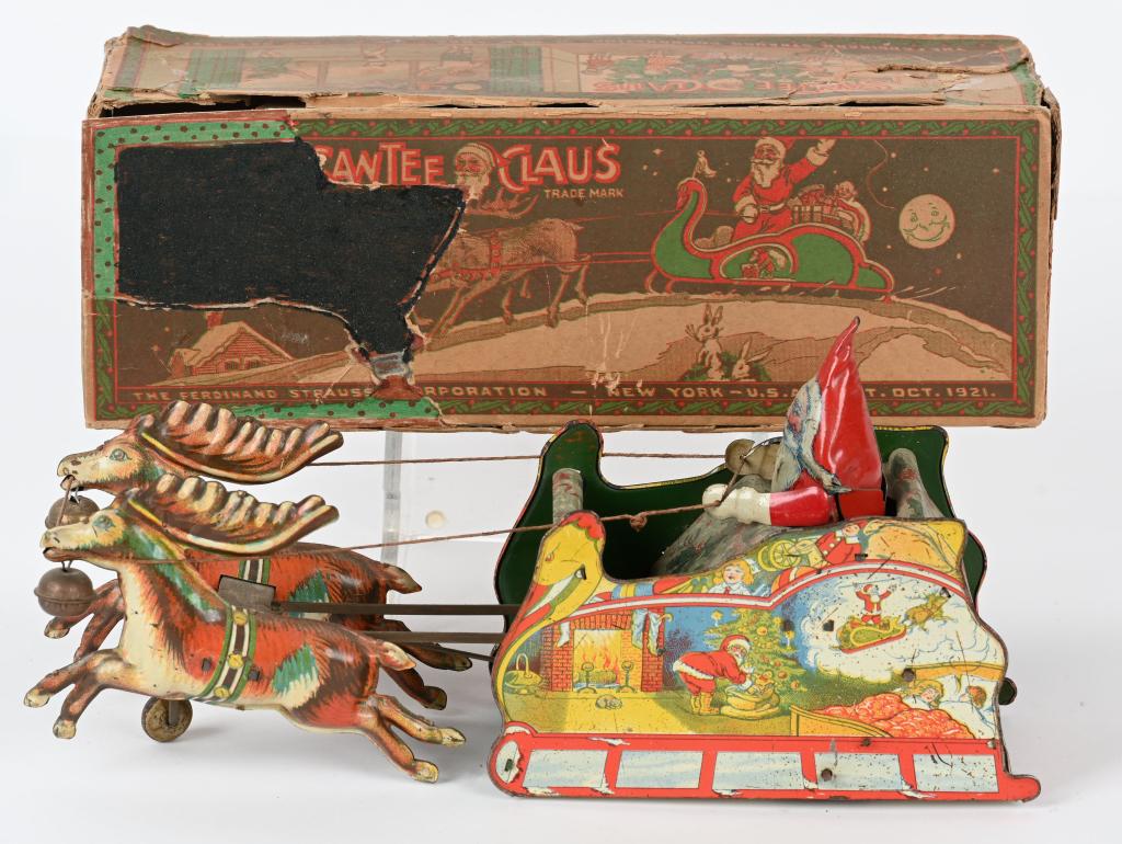 STRAUSS TIN WINDUP SANTEE CLAUS w/ BOX: Strauss tin windup Santee Claus. All original and complete. Toy has great colors and Christmas graphics. Windup works. A nice example of this desirable toy. Comes with partial box. 12" Excellent