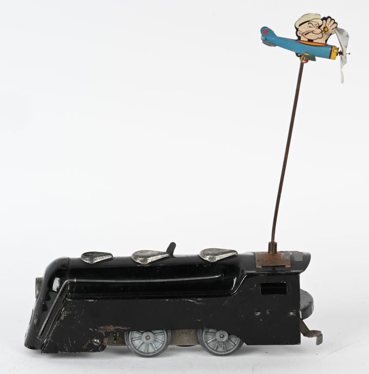MARX PROTOTYPE POPEYE AIRPLANE TRAIN: Marx Prototype Popeye Airplane Train. Marx clockwork Streamline Train Engine with bracket attached that holds Popeye Airplane. Train painted on bottom Model No.346 5/16/36. Wind on Train works. 11"