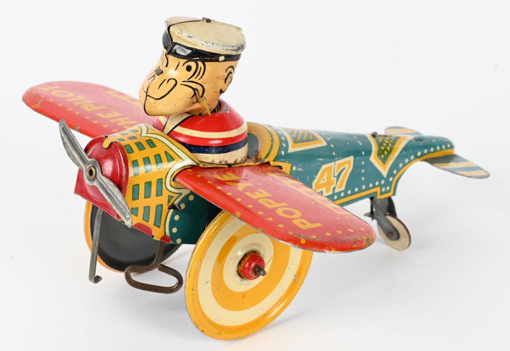 MARX TIN WINDUP POPEYE AIRPLANE "EARLY VERSION": Marx tin windup Popeye Airplane. Early colorful version. All original with nice colors. Windup works. Missing fin on tail that easily replaced. 8" Excellent