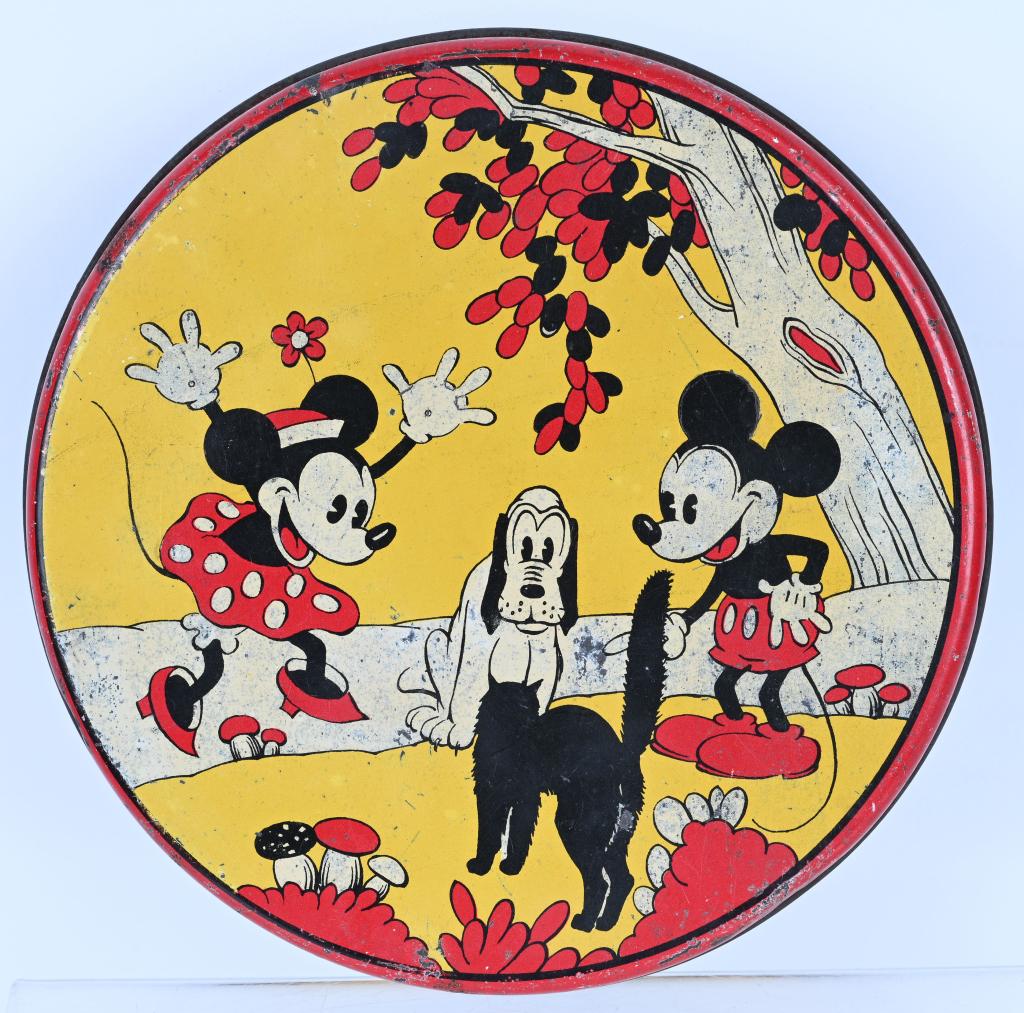 MICKEY & MINNIE MOUSE BISCUIT TIN: Early Pie-Eyed Mickey and Minnie. Mickey, Minnie, and Pluto with Black Cat Biscuit Tin. Great colors and image. A scarce early Disney Biscuit Tin. 7" Excellent
