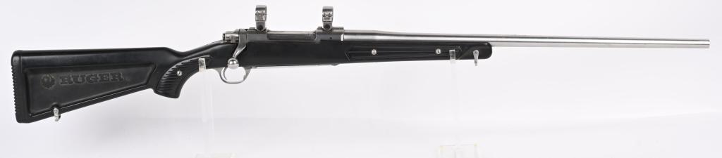 RUGER M77 MARK II STAINLESS WITH PADDLE STOCK: SERIAL NUMBER: 782-32757. BARREL: 24". CALIBER: .338 WIN MAG. MANUFACTURED: 1994. Standard optics ready gun with Ruger factory stainless rings attached to the receiver. Polished stainless finish with 