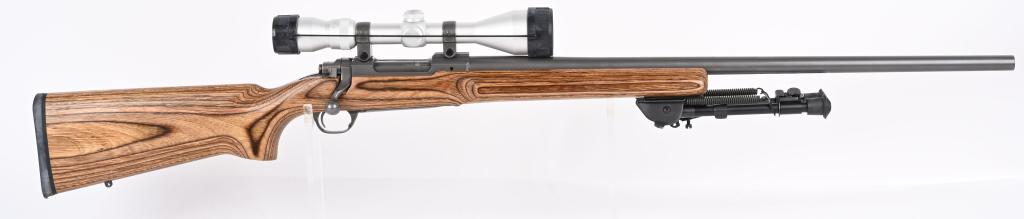 RUGER M77 MARK II STAINLESS WITH LAMINATE STOCK: SERIAL NUMBER: 786-32004. BARREL: 26". CALIBER: .220 SWIFT. MANUFACTURED: 1999. Heavy varmint barrel. Optic gun with Ruger factory rings. In the rings sits a Simmons 3-10X44 scope. Matte stainless ste