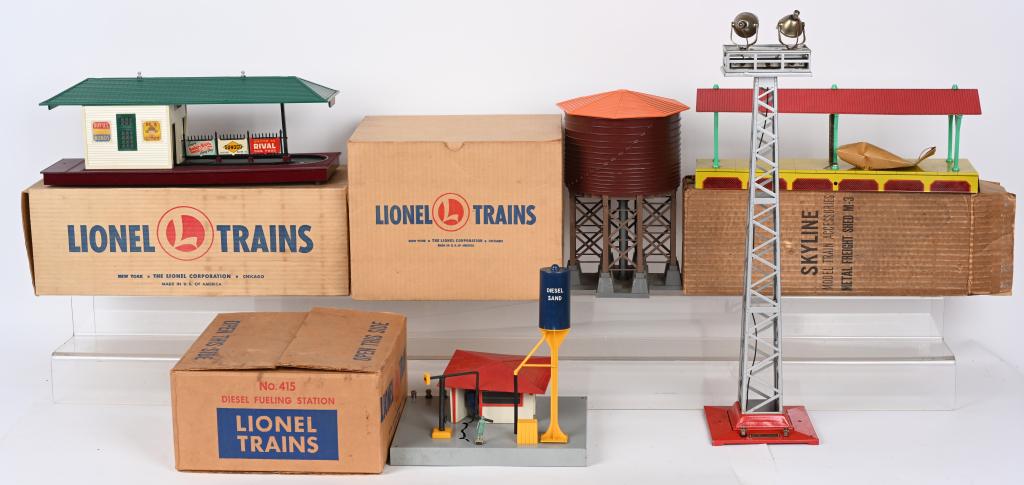 LIONEL ACCESSORIES: Includes #356 Freight Station, #138 Water Tank, #415 Diesel Fueling Station. Floodlight, and Skyline Freight Shed. All in great original condition. Most Boxed. Excellent