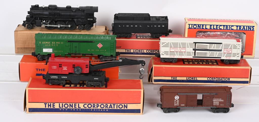 LIONEL 2018 ENGINE & FREIGHT CARS: Lionel #2018 Engine with #6026W Tender. Plus #X2758 Box Car, #6572 Refrigerator Car, #6376 Circus Box Car, #6560 Crane Car, and #16559 Caboose. All in nice original condition. Most with Boxes. Excelle