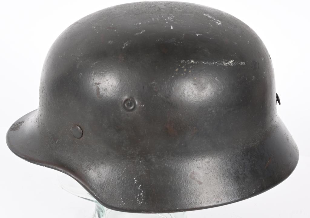 WWII NAZI GERMAN WEHRMACHT M40 COMBAT HELMET Q68: The stamped sheet steel construction helmet retains most of its slightly rough textured feldgrau paint. All three of the liner retaining rivets are intact. The interior of the helmet has the M31 liner