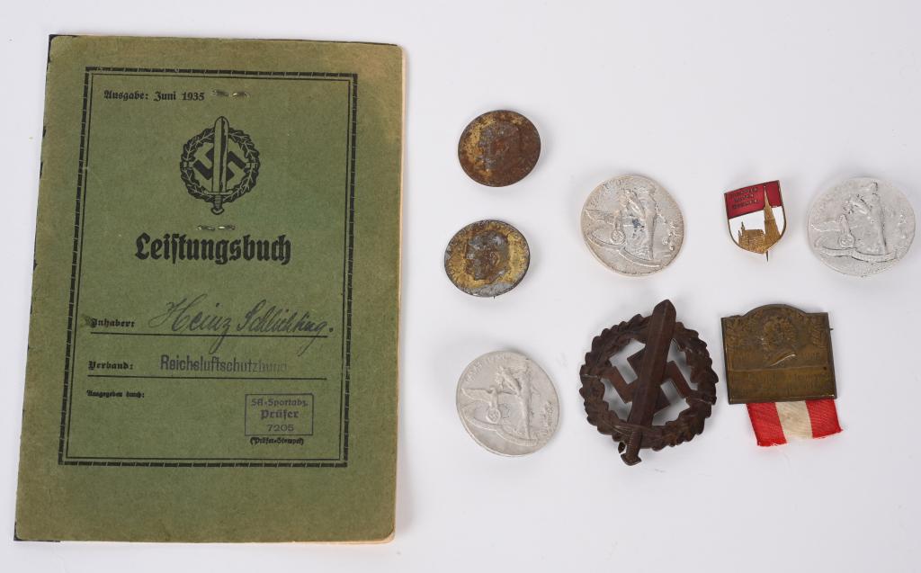 WWII NAZI GERMAN SA SPORTS BADGE BOOK TINNIE LOT: WWII Nazi German lot to include 1) SA Leistungsbuch or Performance Book with photo of the SA Mann with a bronze SA Sports badge numbered to the reverse. 2) Collection of 7 Tinnies and badge including 