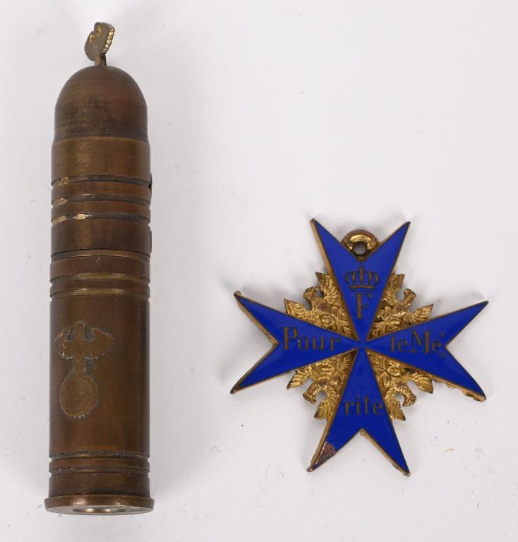WWII NAZI TRENCH LIGHTER & COPY POUR LE MERITE: Military lot to include 1) Copy of a†Pour le MÈrite with minor damage to the blue enamel. Medal is one sided and numbered to the reverse. 2) Nazi Trench Lighter in the form of a shell and i