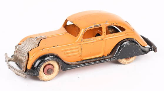 DENT CAST IRON CHRYSLER AIRFLOW TWO-DOOR SEDAN: Dent cast iron Chrysler Airflow Two-Door Sedan. Wonderful example of this toy with delicate castings. Orange body, black frame with nickel grill. No cracks or repairs. 6 1/2". Excellent