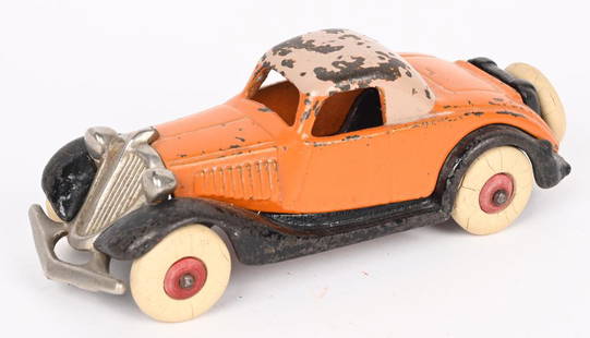 HUBLEY CAST IRON TERRAPLANE COUPE: Hubley cast iron Terraplane Coupe in all original condition. Orange body with tan roof, and black fenders. Original nickel grill and white rubber tires. 6". No cracks or repairs. Very Good-Excellent