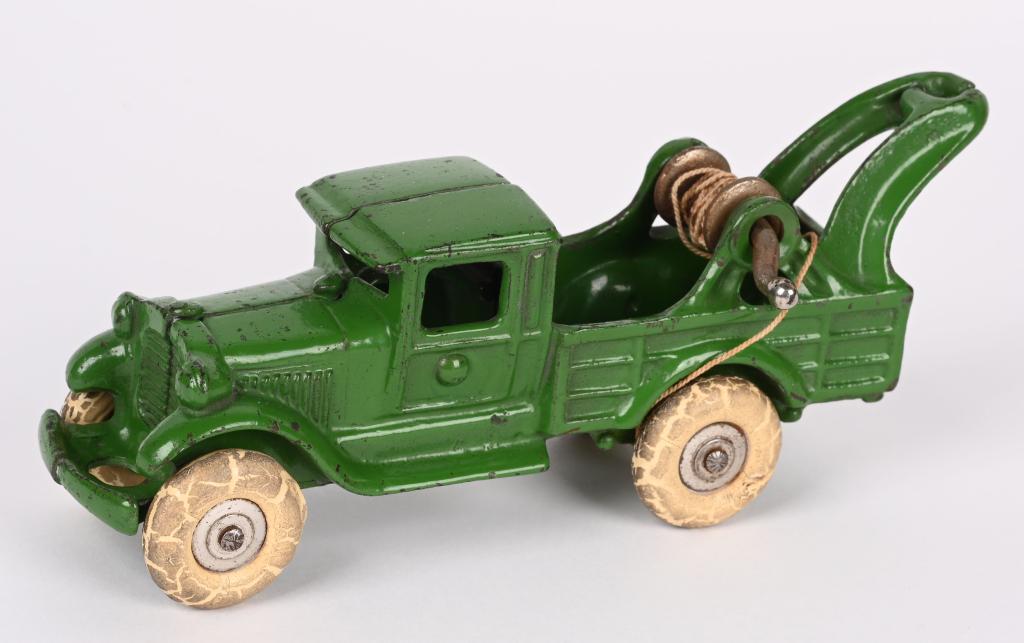 A.C. WILLIAMS CAST IRON WRECKER TOW TRUCK 7": All original with beautiful original green paint. Has original string, but is missing wire hook. 7" Excellent