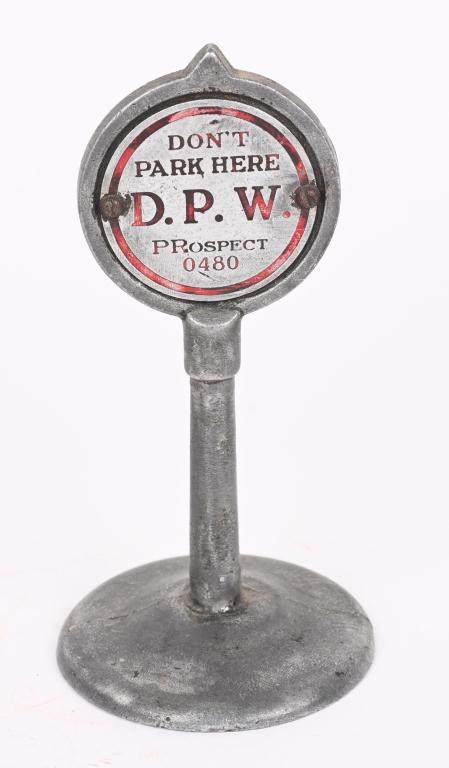 D.P.W. DON'T PARK HERE SAMPLE SIGN: Cast aluminum D.P. W. Don't Park Here sign about the size of an Arcade toy sign. Two sided sample desk sign. 5 1/2" Excellent