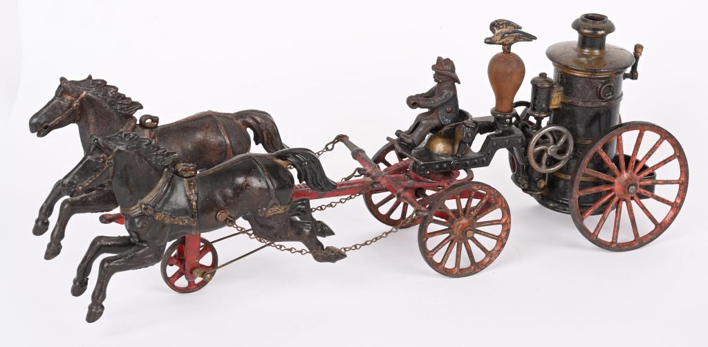 IVES CAST IRON HORSE DRAWN PHOENIX FIRE PUMPER: Late 19th century Ives Phoenix Fire Pumper. Measures 18". Horses and front yoke have touchup. Driver is original. Pumper has touchup and is repaired by hook. Wood eagle perch is replaced. The eagle is