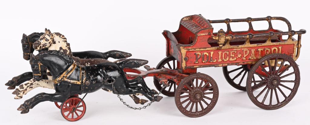 HUBLEY CAST IRON HORSE DRAWN POLICE PATROL: Original Hubley Police Patrol in original paint. Pulled by 3- 9' horses, the toy is 20" overall. No cracks or breaks. There is a grind mark on the right front wheel hub. Overall the toy displays great