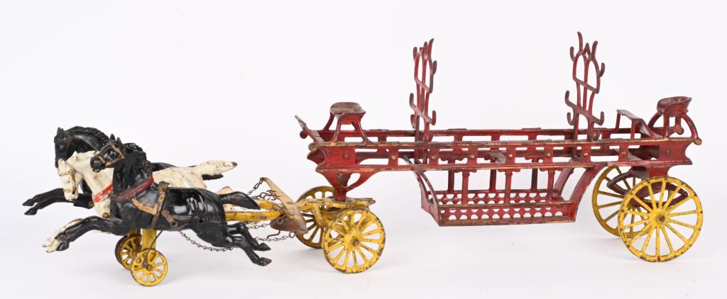 HUBLEY CAST IRON HORSE DRAWN FIRE WAGON: Large original Hubley Fire Ladder wagon. 29" overall with 3- 9" horses. Has 2 original ladder racks, one of which has a factory defect. Very nice toy with above average original paint, and no cracks o