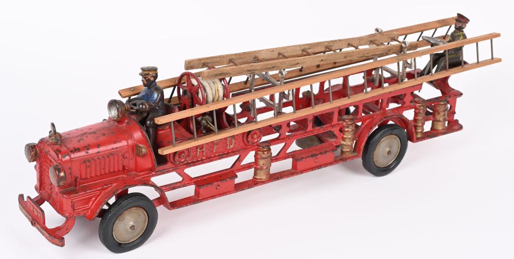 HUBLEY HFD CAST IRON FIRE LADDER TRUCK: Large and impressive Hubley HFD cast iron Fire Ladder Truck. Nice original paint with no cracks or repairs. The hose reel, ladder racks and rear steering wheel are correct cast iron replacements. The