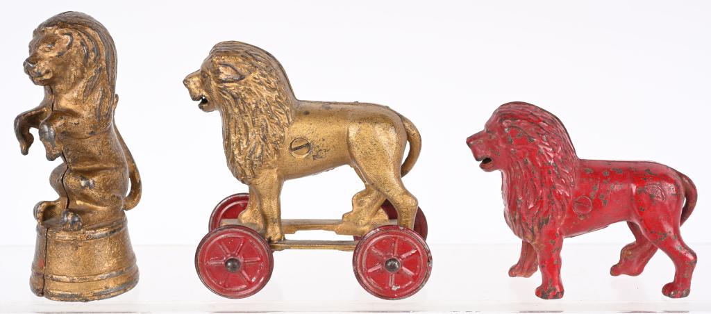 3- CAST IRON LION STILL BANKS: Includes AC Williams Lion on Wheels, Lion on Tub, and Red Lion Still Banks. All in very nice original condition. Largest 7 3/8" Excellent