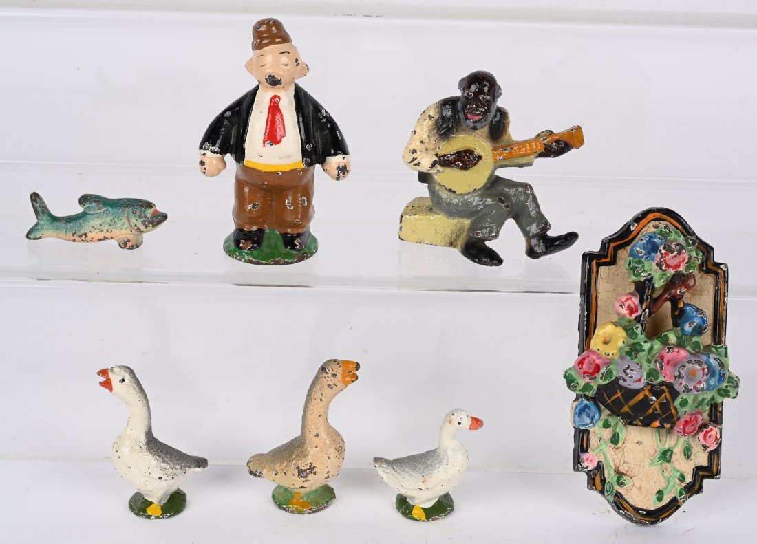 LOT OF FIGURAL CAST IRON: Includes Whimpy, Black Man with Banjo, Flower Door Knocker, Fish, and 3 Geese. All nice original condition. Largest 4" Excellent