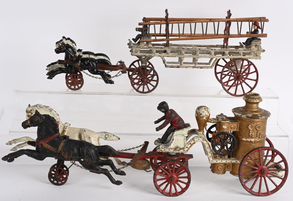 2- ANTIQUE CAST IRON HORSE DRAWN FIRE WAGONS: 1. 18" cast iron Fire Ladder Wagon. Probably made by Hubley. Includes 3 5 1/2" horses, two fireman, ladder racks and wood ladders. Appears all original with no cracks or breaks. 2. Dent fire Pumper Wa