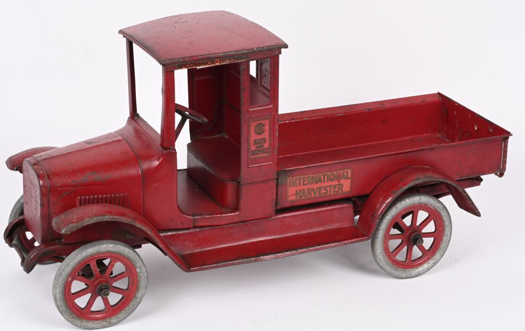 BUDDY L PRESSED STEEL INTERNATIONAL RED BABY: Buddy L pressed steel International Harvester Red Baby. Nice original with mostly original paint and decals. Still has original correct spoke wheels. Inside of bed looks to be period repainted. Tailga