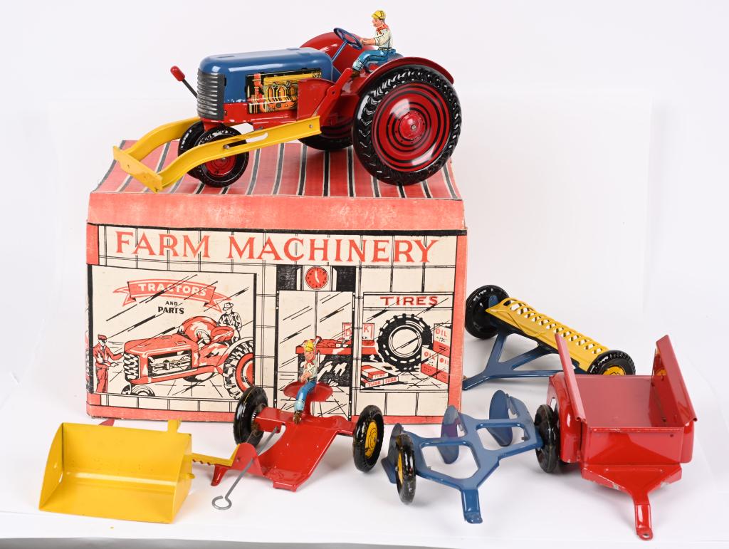 MARX FARM MACHINERY SET w/ BOX: Marx pressed steel Farm Machinery Set. Includes Tractor, Trailer, and Accessories. All look basically never played with condition. Comes in Tractor Sales and Service Building Box with Instructions. 15