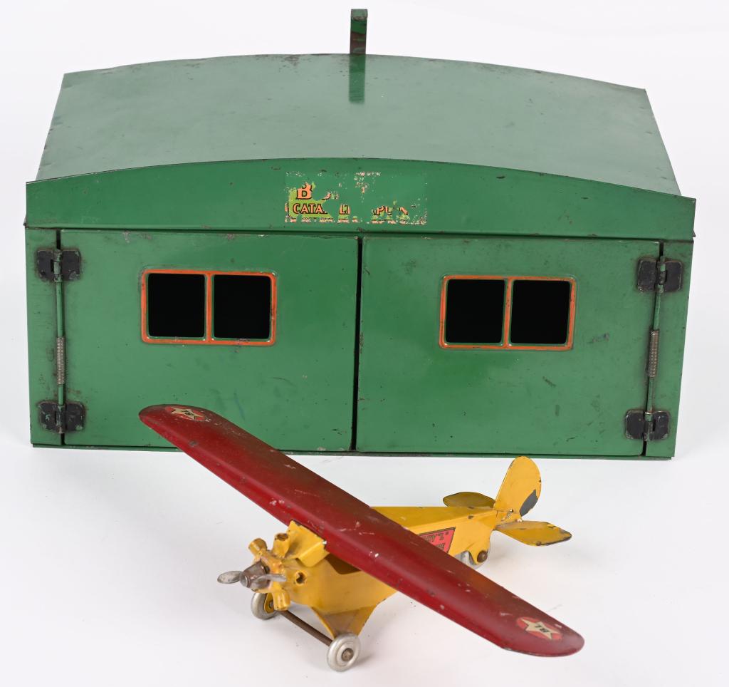 BUDDY L PRESSED STEEL CATAPULT AIRPLANE & HANGER: Buddy L pressed steel Catapult Airplane and Hanger. Scarce green Hanger with Yellow Airplane. All original with very nice paint. Hard to find version in this condition. Hanger measures 12" Excellent