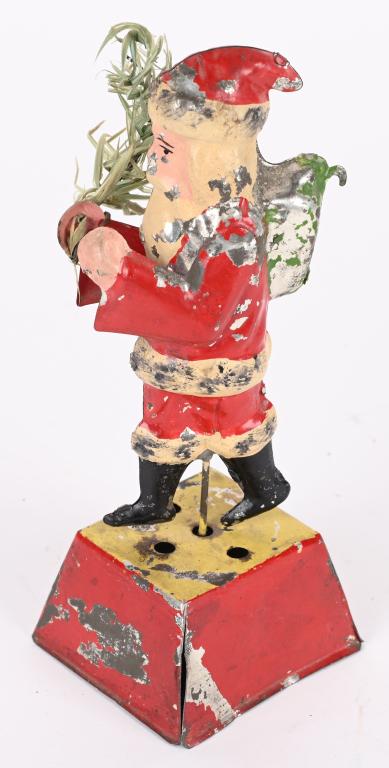GERMAN TIN WINDUP MUSICAL SANTA GO ROUND: German hand painted tin windup Musical Santa Claus Go Round. Beautiful all original Santa Figure holding a Feather Tree. Wind the toy and Santa goes around and music plays. A very wonderful toy. 7 1/2