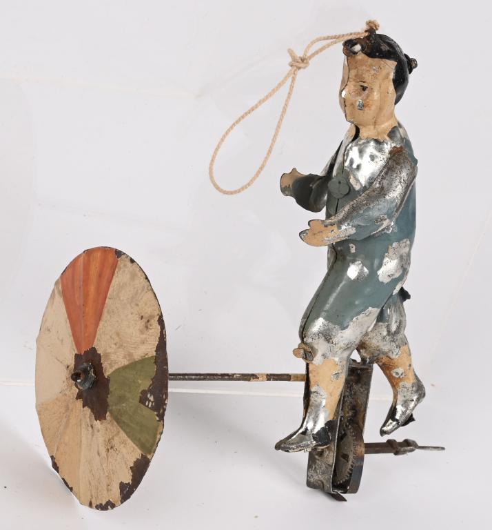 GERMAN WINDUP HAND PAINTED TIN FLYING MAN: German windup hand painted tin Flying Man with Umbrella. All original made to fly by a string. Has some typical wear. Windup works. 5 1/2" Very Good-Excellent