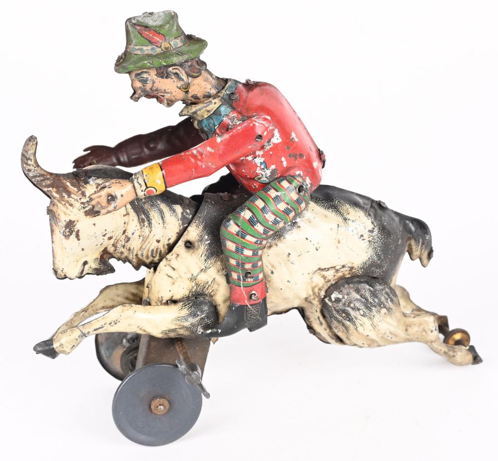 GERMAN TIN WINDUP MAN ON GOAT: German tin windup Man on Goat. All original with some normal wear. Windup works but could use adjustment. 7" Excellent