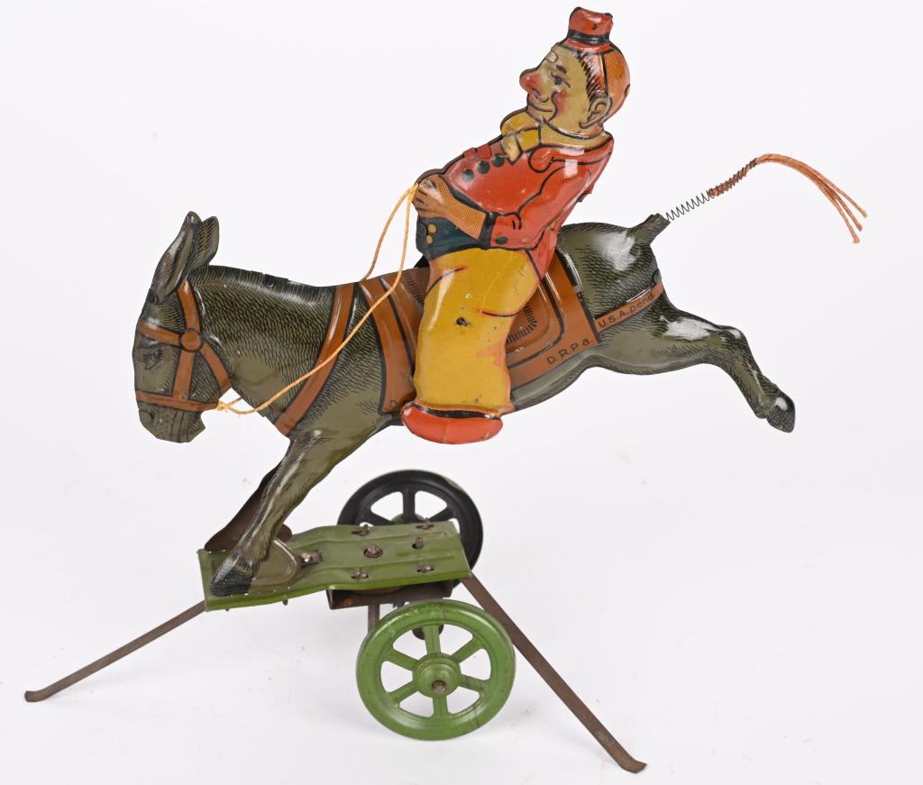 GERMAN TIN WINDUP CLOWN RIDING DONKEY: German tin windup Clown Riding Donkey. All original with nice colors. Windup works. 9" Excellent