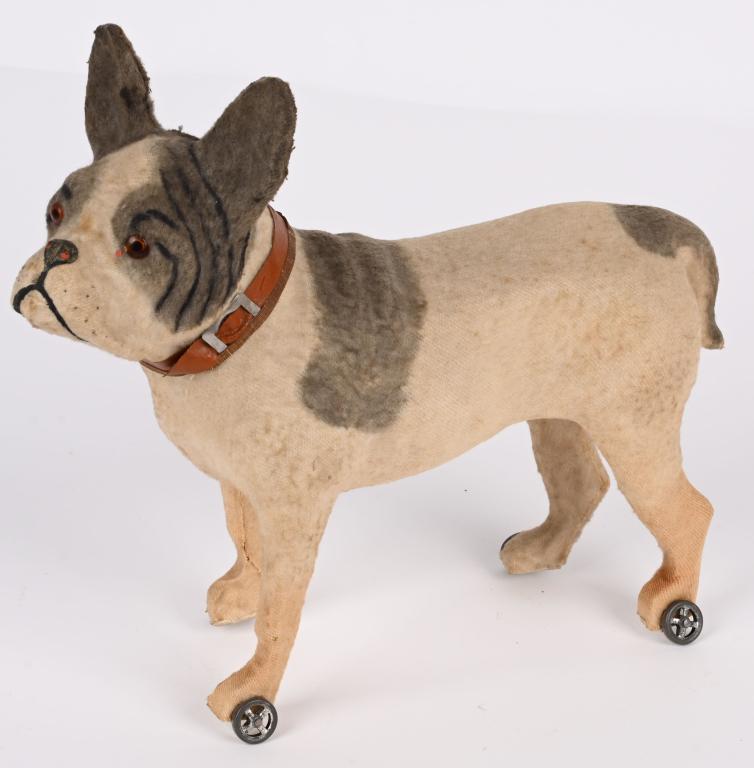GERMAN FELT COVERED BULLDOG ON WHEELS: German felt covered Bulldog on Wheels. Composition body with wood legs. Has glass eyes. Rolls on tin wheels. A very nice looking Bulldog in wonderful original condition. 12" Excellent