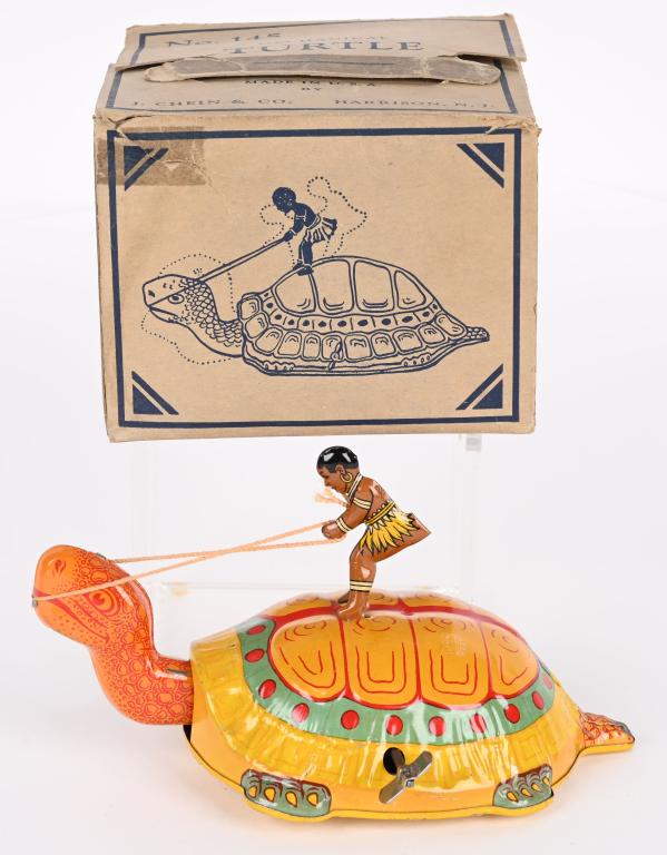 CHEIN TIN WINDUP NATIVE ON TURTLE w/ BOX: Chein tin windup Native on Turtle. Scarce yellow version. Windup works. Boxed 5 1/2" Excellent