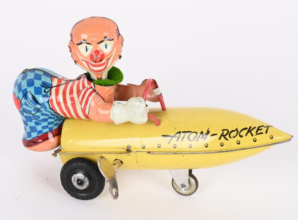 KARL BUB TIN WINDUP ATOM ROCKET: Western Germany tin windup Atom Rocket. All original with great colors. Windup works. 7" Excellent