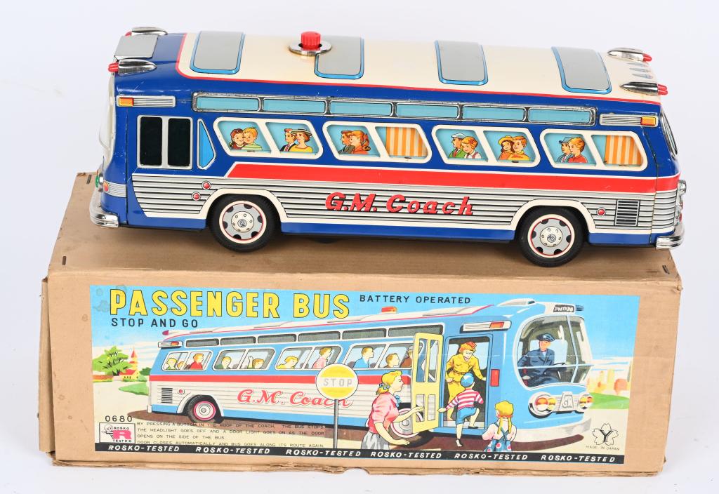 YONEZAWA BATTERY OP G.M. PASSENGER BUS w/ BOX: Scarce and large G.M. Coach Passenger Bus battery toy, with the original colorful box. Made in Japan by Yonezawa. When tested the motor worked and some of the lights went on, but the bus did not move