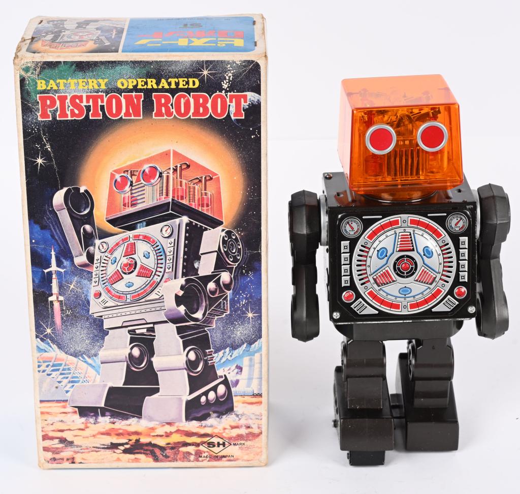 HORIKAWA BATTERY OP PISTON ROBOT w/ BOX: Japan battery operated Piston Robot. Piston Head version. All original and complete. Nice clean condition. Worked when tested. Boxed with Inserts. There is a small chip on the hinge of the battery box